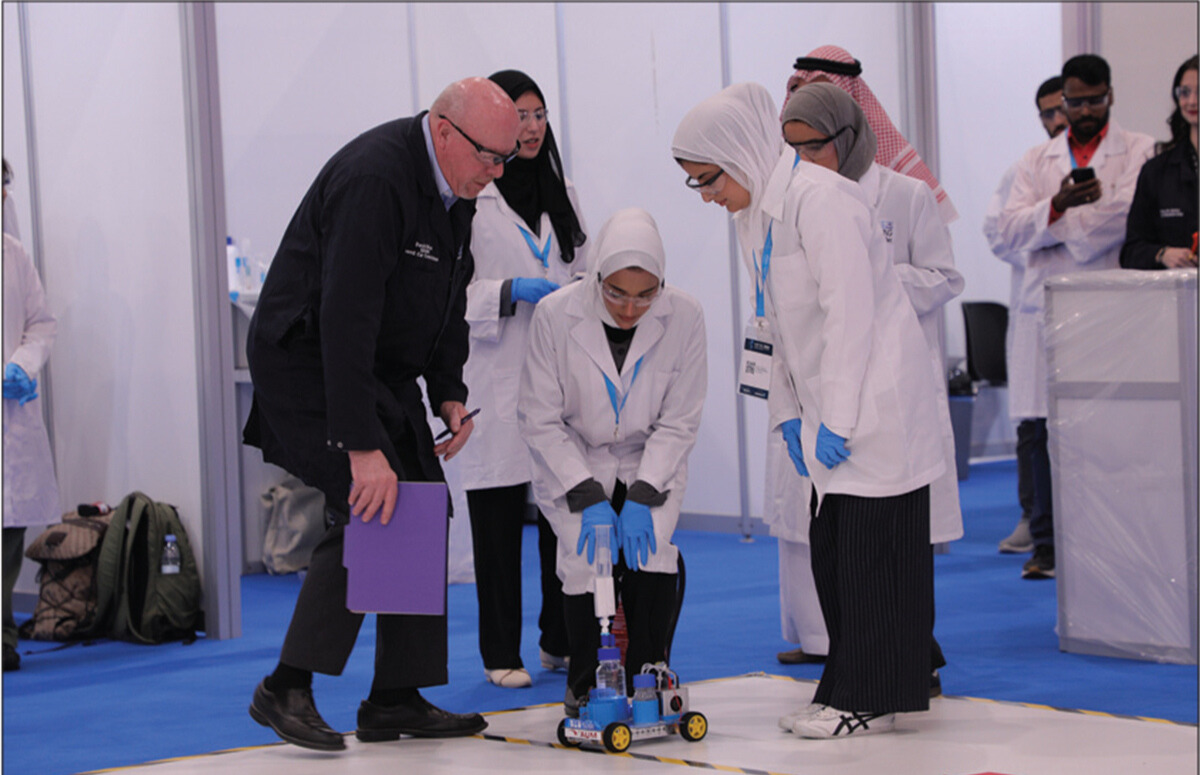 The Chem-E-Car Competition returned to the Middle East region with a lineup of six competing universities. Here, Prof. David Dixon, South Dakota School of Mines and Technology, assists students from American Univ. of the Middle East during the competition. 