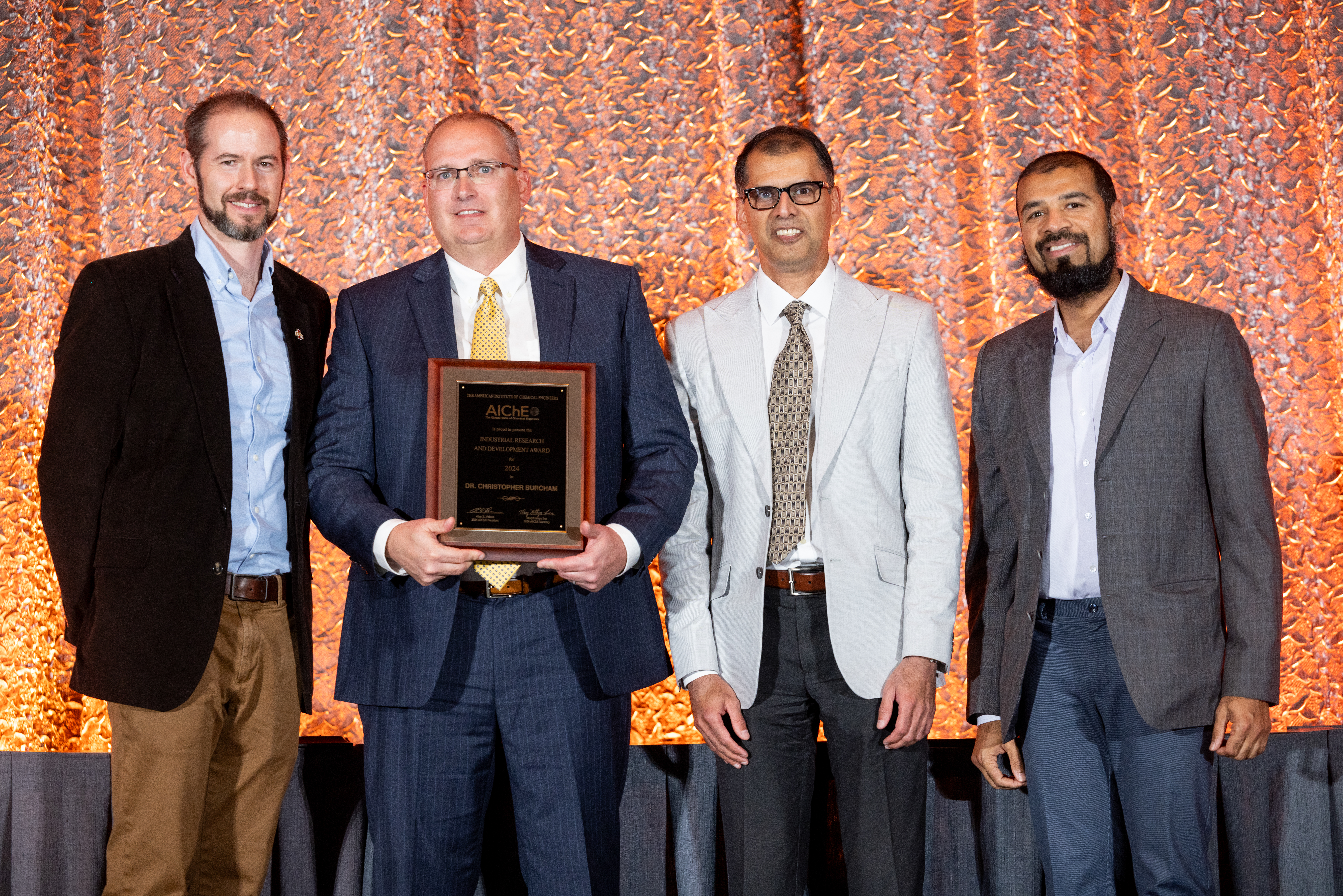 Dr. Christopher Burcham (second from left) with Awards Selection Committee Chair Nigel Reuel (far left), and AbbVie's Shailendra Bordawekar (second from right) and Moiz Diwan (far right)