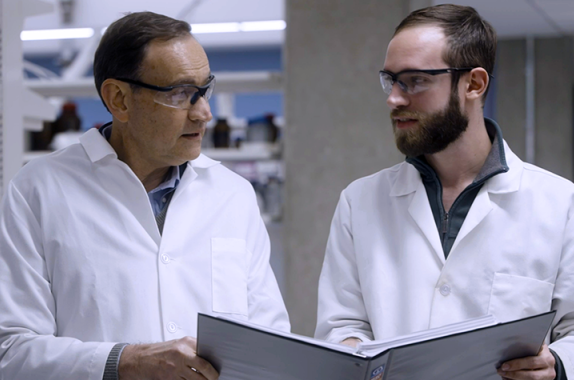 Fabio Ribeiro (left) consults with a colleague in his lab.