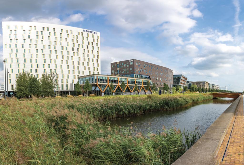 Figure 1. The business district in Hoofddorp, The Netherlands, offers plenty of community and green spaces for employees and the public. The area is located close to amenities like restaurants and childcare services, and it is easily accessible by rail.